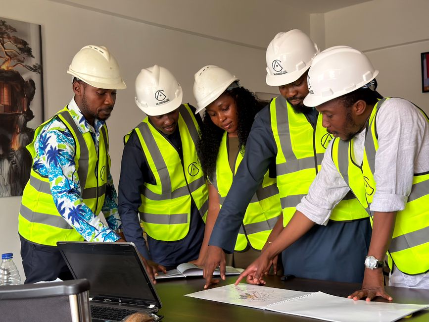 A close-up shot of several professionals' hands pointing at architectural blueprints on a large, bright table, illustrating specialized expertise and planning.